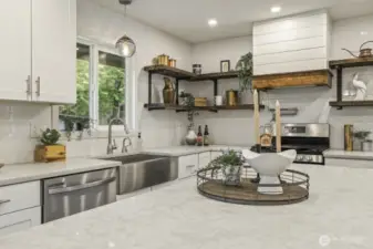 Chef’s kitchen equipped with stainless steel appliances, gas stove, and convenient pot filler