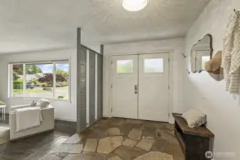 Stylish slate tile and double front doors set the tone in this spacious, welcoming entryway.