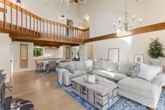 This true great room impresses w/ open-concept design—catwalk above, seamless flow to dining & kitchen, & an airy layout that brings everyone together in one expansive, connected space