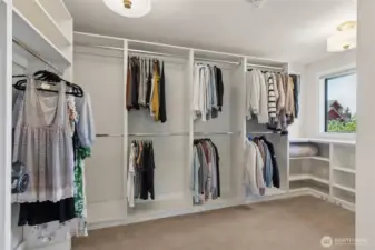 Custom walk-in closet delivers wow-factor storage—featuring built-in shelves, extensive clothing racks & dedicated shoe storage to keep everything organized & within easy reach