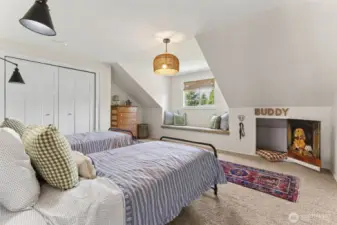 Charming bedroom w/ angled ceilings & a built-in window bench—full of personality & extra space below, perfect for a cozy reading nook, pet retreat, or secret hideaway for play or rest