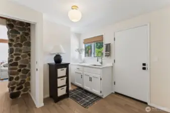 Main floor mudroom offers a private entry point—perfect for coming in from the outdoors to drop gear, freshen up, & keep the rest of the home clean & organized