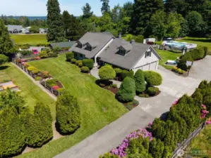 Driveway leads to a spacious 3-car garage & features a basketball hoop—perfect for extra parking, storage, & outdoor fun the whole household can enjoy