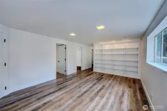 Another angle of the rec room with built-in shelving
