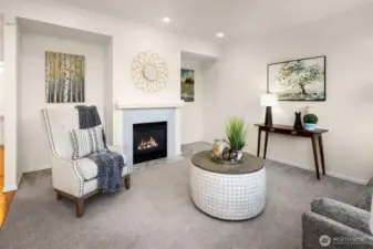 Family room adjacent to kitchen features a cozy gas fireplace.
