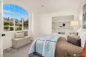Opposite the bed are built in shelves and cabinets which very easily can be converted into a closet, making this a perfect 5th bedroom on the upper level (making this a 6 bedroom home).
