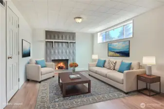 Downstairs family-room has so much potential. Imagine evenings with a warm fire. Virtually staged photo, does not reflect owners personal items.
