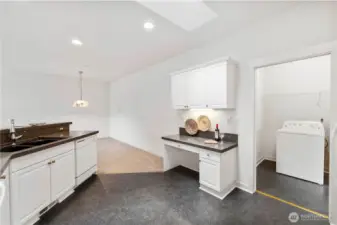 Kitchen comes with extra desk space and pocket door to laundry/garage