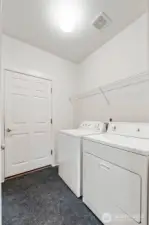Laundry room with garage door access and pocket door to the kitchen