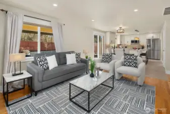 Looking from the fireplace back into the informal dining & kitchen area.