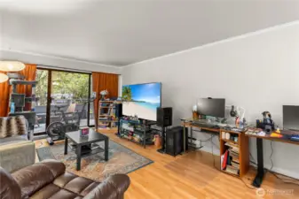 Sliding glass door frames the lush greenery which makes working from home even more enjoyable!