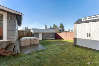 Backyard with shed and detached garage. Hot tub does not stay