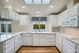 The recently refreshed kitchen offers quartz countertops, a brand new cooktop, and a skylight to keep it bright.