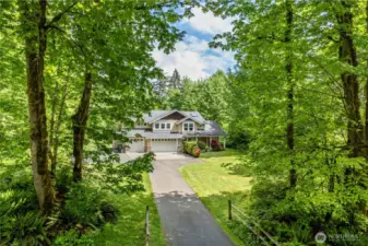 Tree lined entry opens to 1.52 acres of private bliss.  The outlook from house will never change as the properties across the street are owned by lake front houses and reserved for septic drainfields.