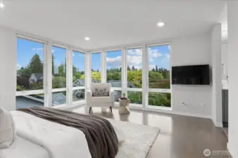 Sprawling primary suite with floor to ceiling windows