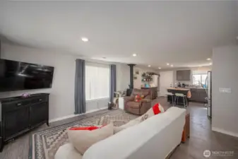 Living room looking toward kitchen with wood stove