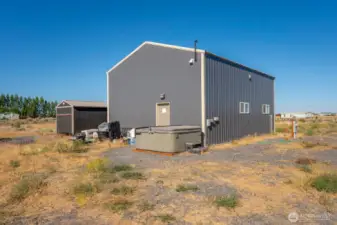 Rear of shop with hot tub and extra shed