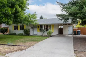 Charming curb appeal with cheerful shutters and welcoming entry.