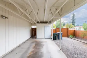 Covered carport with additional storage space.