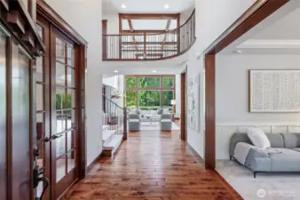 Step inside to elegance. Formal office to the left with glass pane French doors, and formal living room to the right. Straight ahead to the gorgeous Great room with floor-to-ceiling windows, and overhead breezeway on the 2nd floor.