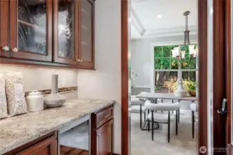 Butler's Bar with beverage fridge, and cabinetry.
