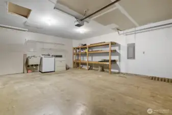 Spacious 2 car garage with ample storage space, utility sink, washer and dryer.