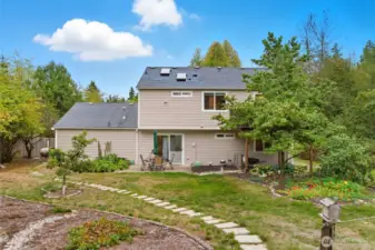 Backyard with multiple features including fruit trees, plenty of garden space, patio and deck space, roomy shed, and partially fenced yard.  Enjoy!