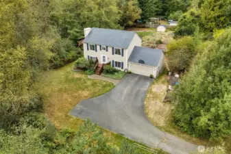 Drone view of home and front and back yard space.