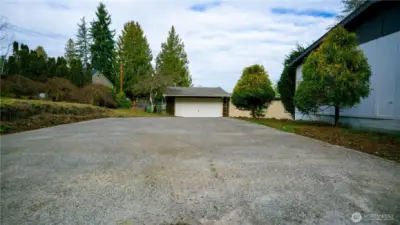 Large cement slab parking area plus oversized 2 car garage