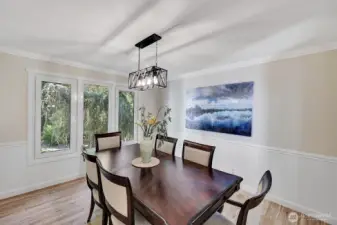 Formal dining room has practical wainscotting on walls
