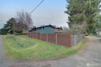 Fully fenced yard sits off an alley, great candidate for possible future development