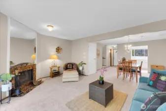living room shot into dining room.  Cozy fireplace, load of natural light and lots of room to entertain!