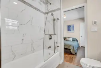 Main floor full bathroom with cast iron tub and radiant floor heat