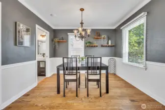 Shelving and coat closet with attic access in the dining room