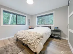 Primary bedroom, queen bed pictured, with walk in closet