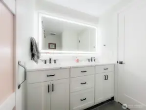 Bathroom with heated mirrors and towel rack