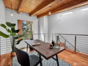 The natural wood beams and tree view gives this loft space a rustic feel...
