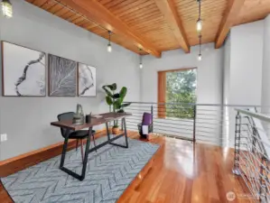 The natural wood beams and tree view gives this loft space a rustic feel