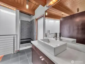 En suite bathroom w/ luxurious shower & frosted window, letting in lots of light, while maintainig privacy.