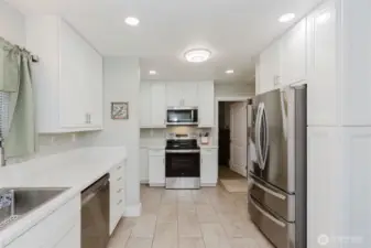 The newer kitchen shines with quartz countertops, stainless steel appliances, and sleek cabinetry—ideal for home chefs and entertainers.