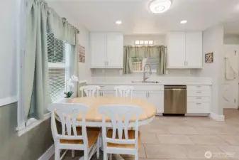 Easy to keep clean tile flooring in the kitchen plus room for your dining table!