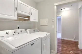 Laundry room with door, leading to the stairwell to garage. Washer/dryer included.