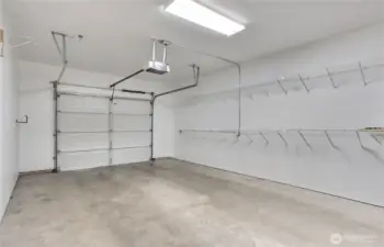 Spacious garage with additional storage space at front end of the garage. Lots of shelving.