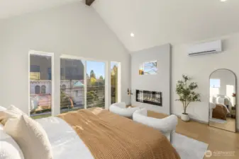 This sun-drenched bedroom comes with vaulted ceilings, offering a spacious and airy atmosphere.