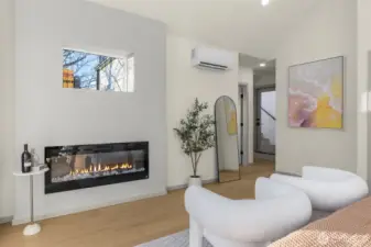 Primary suite is anchored by a modern linear fireplace and minimalist design.
