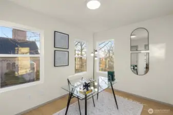 Bright and versatile bonus room with large windows, ideal for a home office or creative studio.