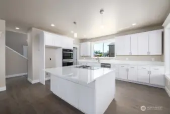 KItchen with double oven Jenn Aire Cooktop, quartz counters