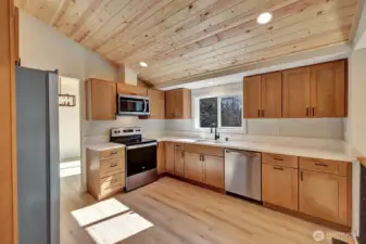 Brand new kitchen boasts new cabinets, quartz counters and stainless steel appliances.