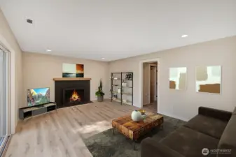 Lower level family room with wood burning fireplace and a HUGE 8' glass sliding door to keep the room filled with light! Virtually staged