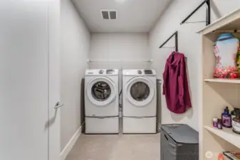 Utility room with washer and dryer upstairs